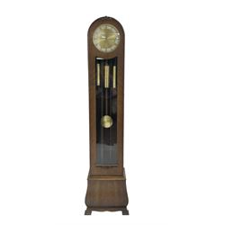 Juhngans - 1930s oak cased 8-day chiming grandmother clock, round toped case with a fully glazed trunk door and visible brass cased weights and pendulum, two part dial with a gilt centre, brass moon hands and applied brass roman numerals, three train chain driven movement chiming the quarters and hours on 8 gong rods.  