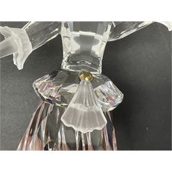 Swarovski Crystal Masquerade trilogy; 1999 Masquerade Pierrot, 2000 Columbine, 2001 Harlequin all with accompanying plaque, stand and original box, together with a glass display case with mirrored back and sides 