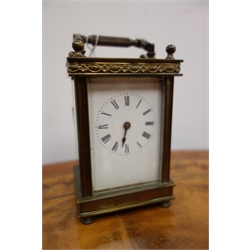  Early 20th century brass cased carriage clock, the enamel dial with Roman numerals and eight day movement H13cm excluding swing handle, and a Victorian brass cased drum alarm clock, enamel dial with Roman numerals and secondary alarm set dial and exposed balance wheel, and another nickel cased drum clock by the Ansonia Clock Co. with simulated tortoiseshell carrying case (3)  