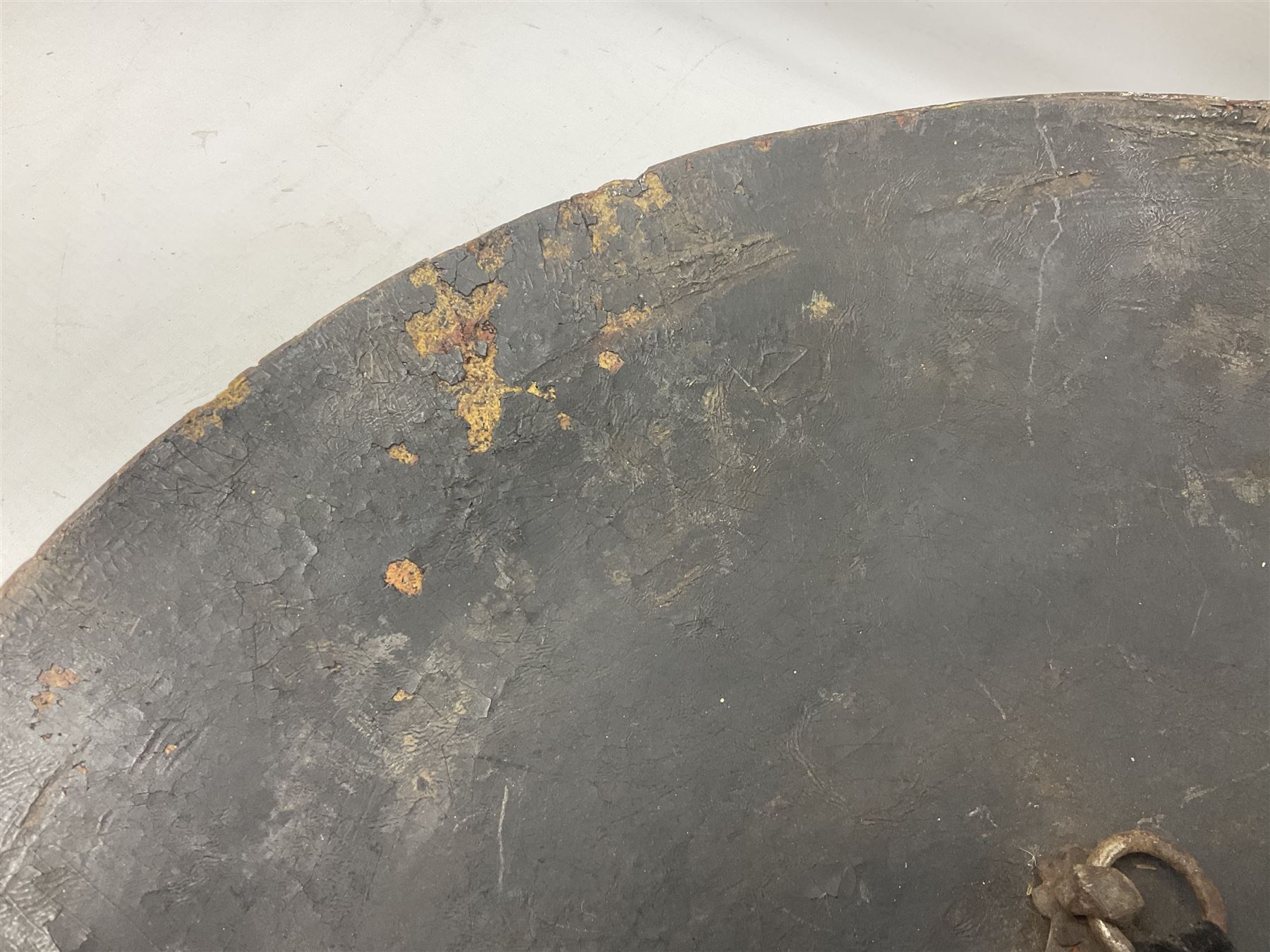 Indian black lacquered hide shield/dhal, of circular convex form fitted at its centre with four pierced iron bosses, each of hemispherical form with wide brims, the bosses corresponding on the inside with four iron rings for enarmes D53.5cm