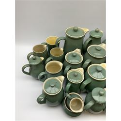 Denby Manor Green pattern tea service, comprising of three teapots, twelve coffee pots of various sizes, four hot water jugs with lids, seven jugs, eleven teacups, four mugs, seventeen saucers, six sugar bowls, two sugar bowls with lids and eleven side plates.  