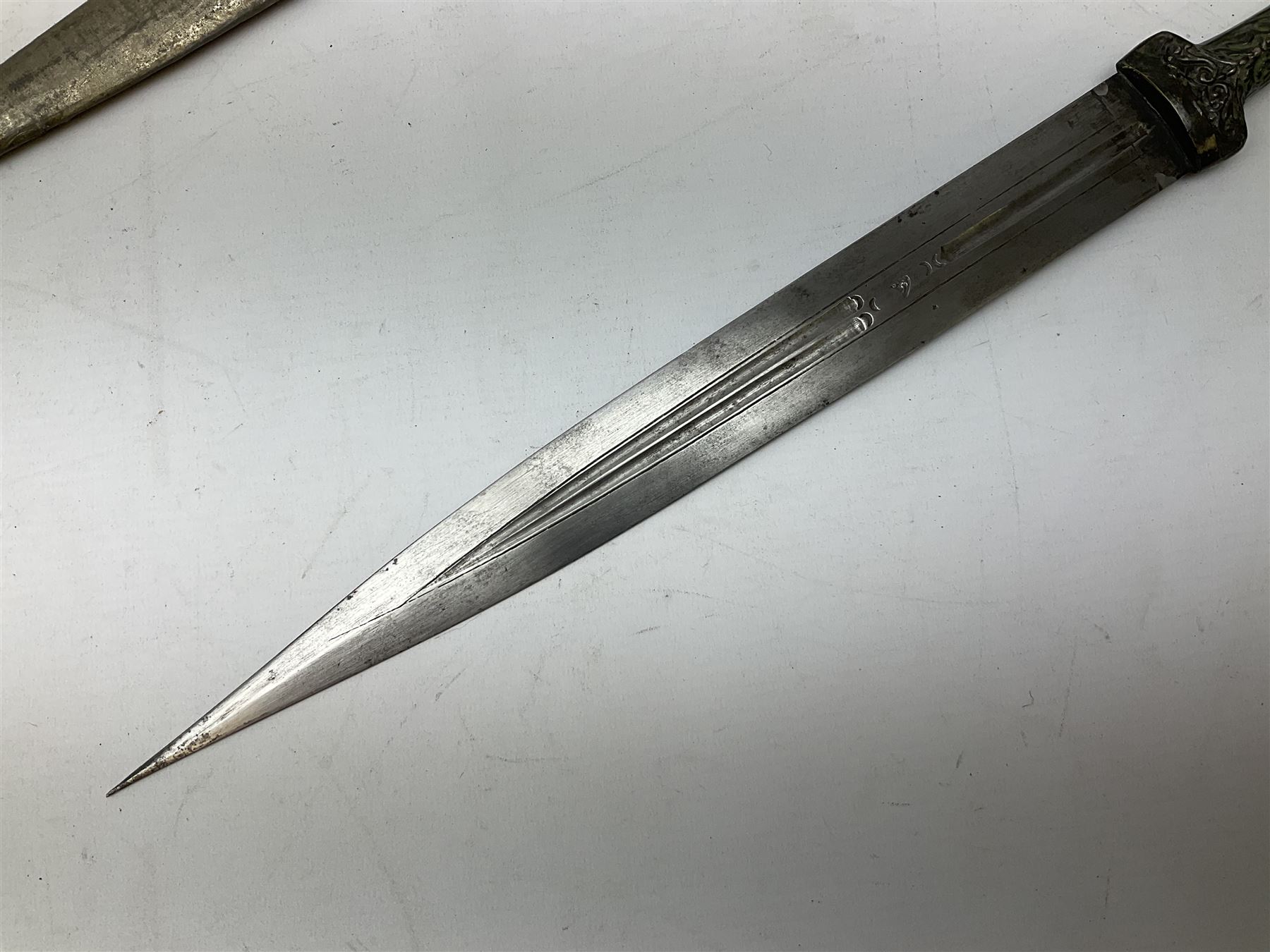 19th century Khanjali dagger, 33.5 cm double edged fullered blade with stamped makers marks, ornate cast grip, with engraved white metal scabbard, 46cm overall
