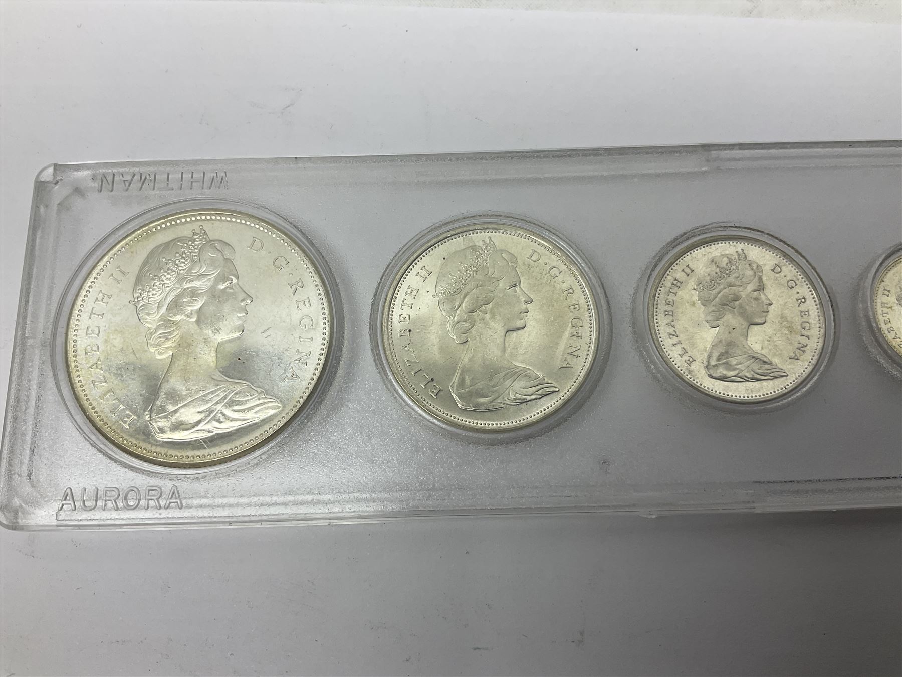 South Africa 1897 one shilling, 1967 one rand, Ireland 1928 two shillings and sixpence, Netherlands 1930 two and a half gulden, two Queen Elizabeth II Canada one dollar coins dated 1958 and 1964, 1967 six coin set in plastic holder etc