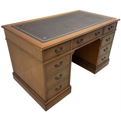 Cherrywood twin pedestal desk, rectangular leather inset top over central fall front with keyboard slide and two drawers, fitted with two drawers and cupboard, on bracket feet