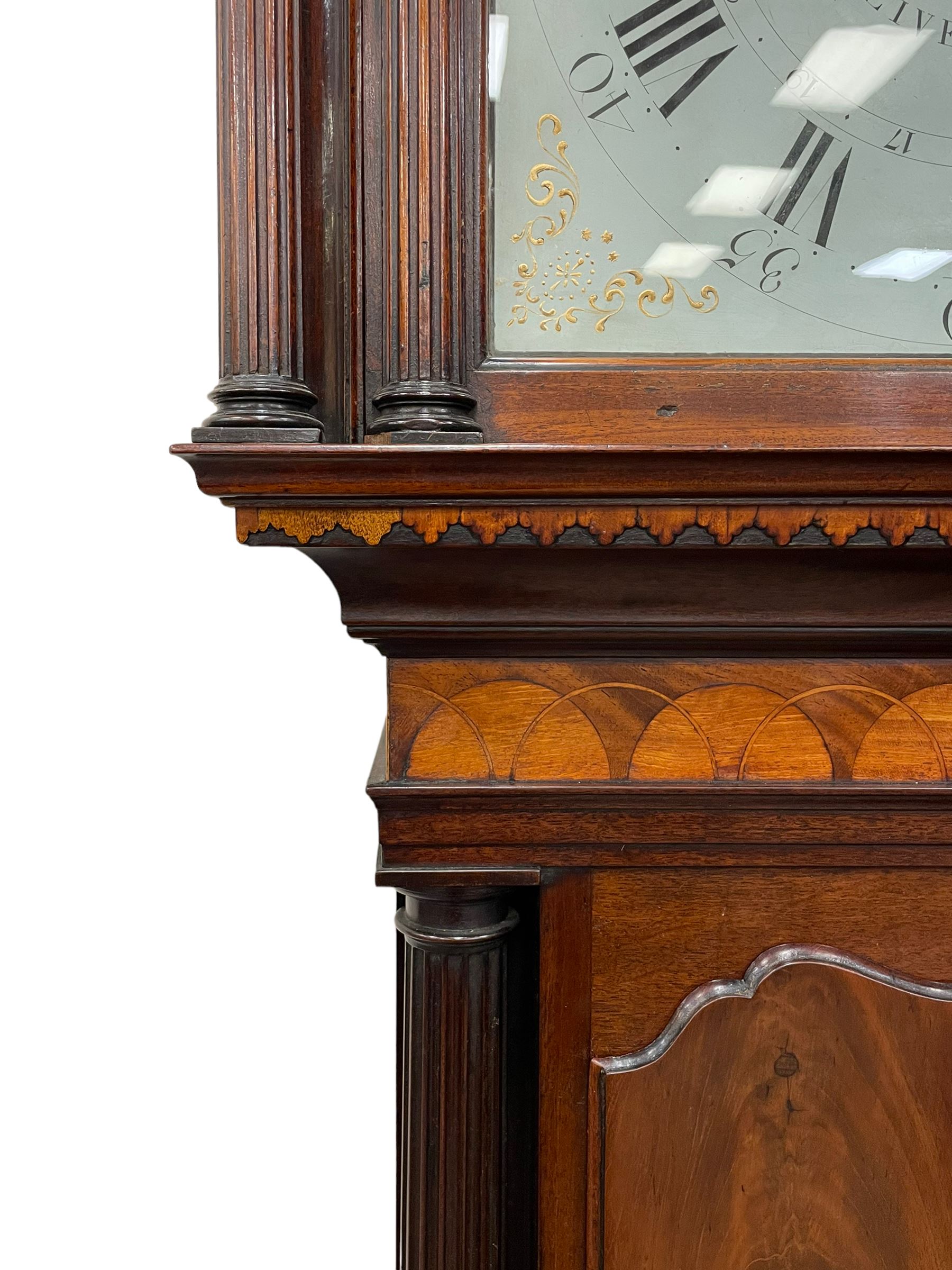 Penlington of Liverpool – early 19th century 8-day mahogany longcase clock, swans neck pediment with three turned wooden finials and verre eglomise panels, trunk with reeded columns and wavy topped door, plinth with canted corners on bracket feet, painted break-arch dial with Roman numerals and five-minute Arabic’s, centre sweep calendar and seconds hands, blue steel serpentine hands, signed beneath a painted rolling moon in the arch PENLINGTON, LIVERPOOL, eight day four pillar movement, anchor escapement and rack striking on a bell. With pendulum and weights.  The Penlington family were prolific clockmakers in 19th century Liverpool working from several addresses in the city, also recorded as chronometer and chronograph makers.