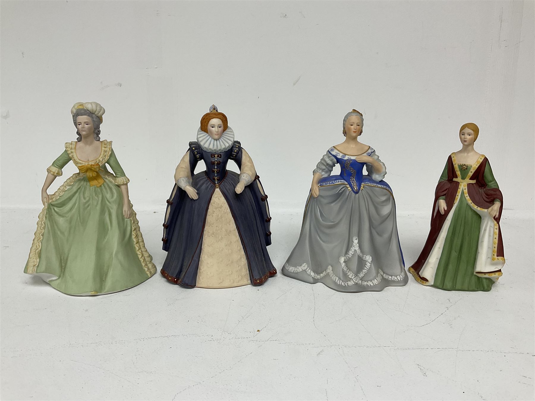 Four limited edition Franklin Mint figures of queens comprising Elizabeth I, Isabella of Spain, Catherine the Great and Marie Antoinette