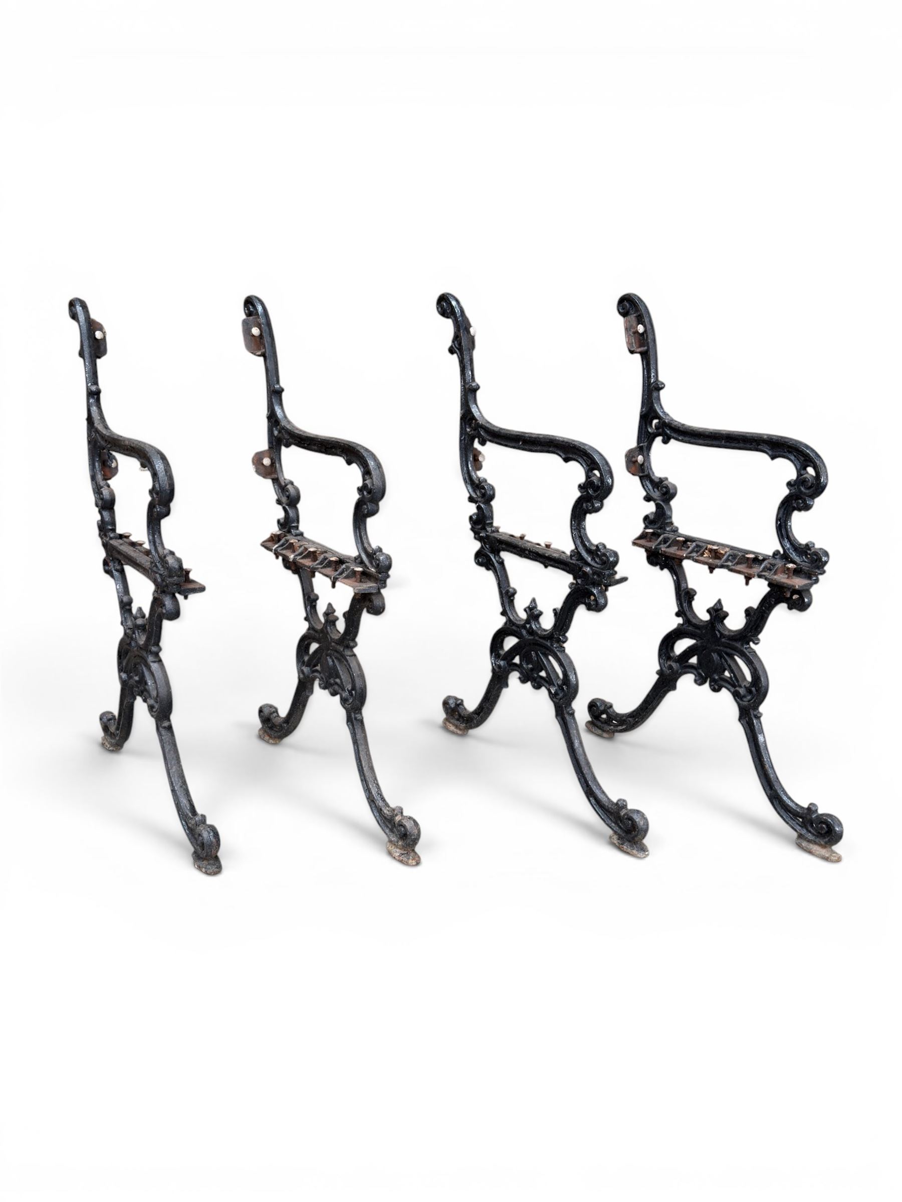 Carron Foundry - two pairs of 19th century cast iron garden bench ends, ornate detail with arms and X shaped legs,finish in black paint, the design no. 110396, first registered 13 July 1857 (see illustration), width as desired
