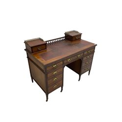 Maple & Co - Edwardian mahogany twin pedestal desk, the raised back with spindle gallery and open shelf to centre flanked by two trinket drawers, rectangular top with inset writing surface, fitted with one long and eight short graduating drawers flanked by fluted uprights, raised on brass and ceramic castors, stamped to central drawer