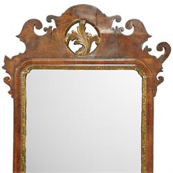 18th century Chippendale design walnut wall mirror, shaped and scroll carved cresting with central gilt acanthus roundel, moulded frame with inner gilt slip, shaped apron and scroll carved corners