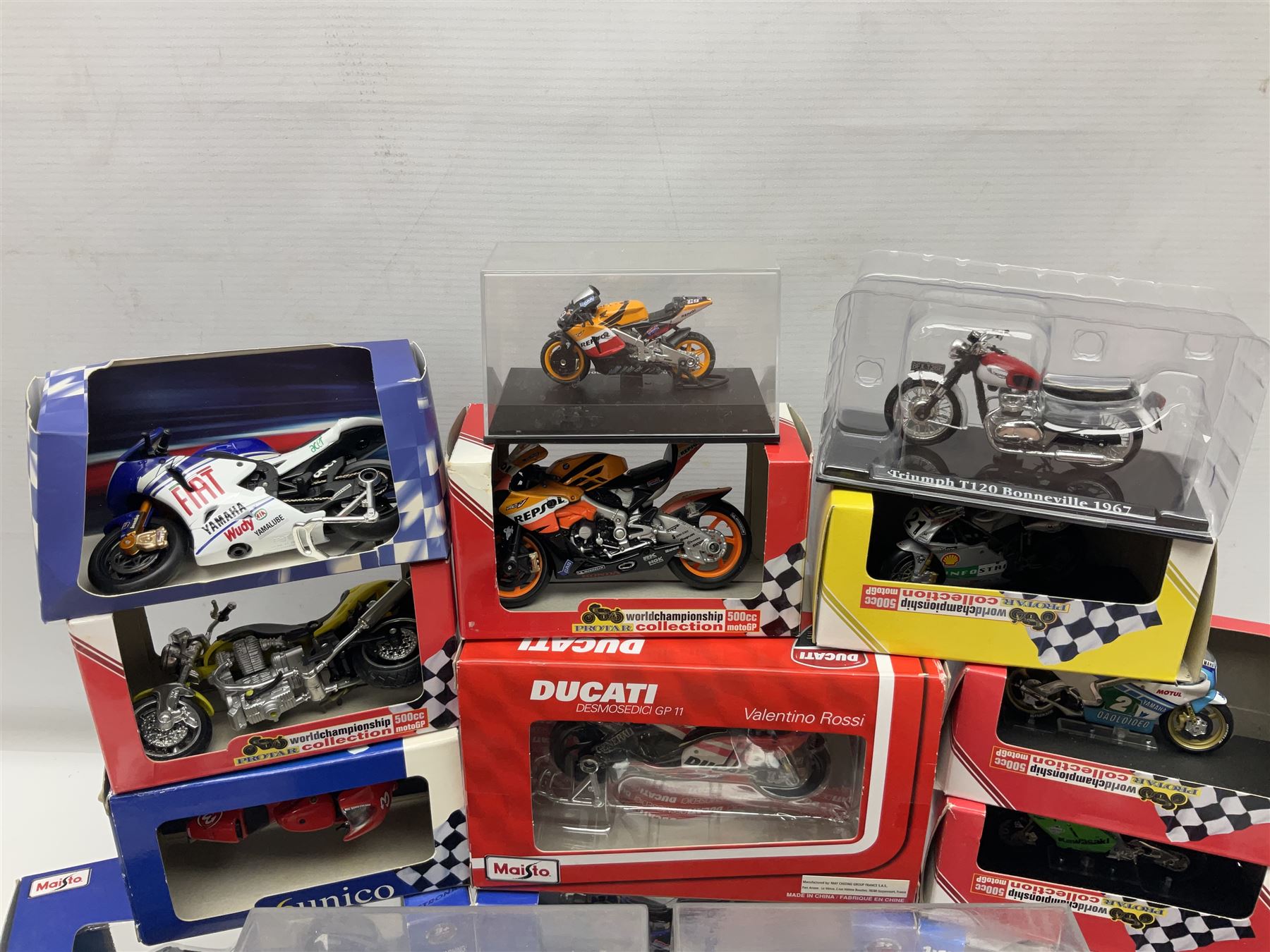 Fifty-one die-cast models of motorcycles by Maisto, Protar Italeri, Welly etc; many in perspex display boxes, some in window boxes and some unboxed