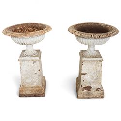 Pair of 19th-century Victorian white painted cast iron tazza-shaped urns with lobed unders...