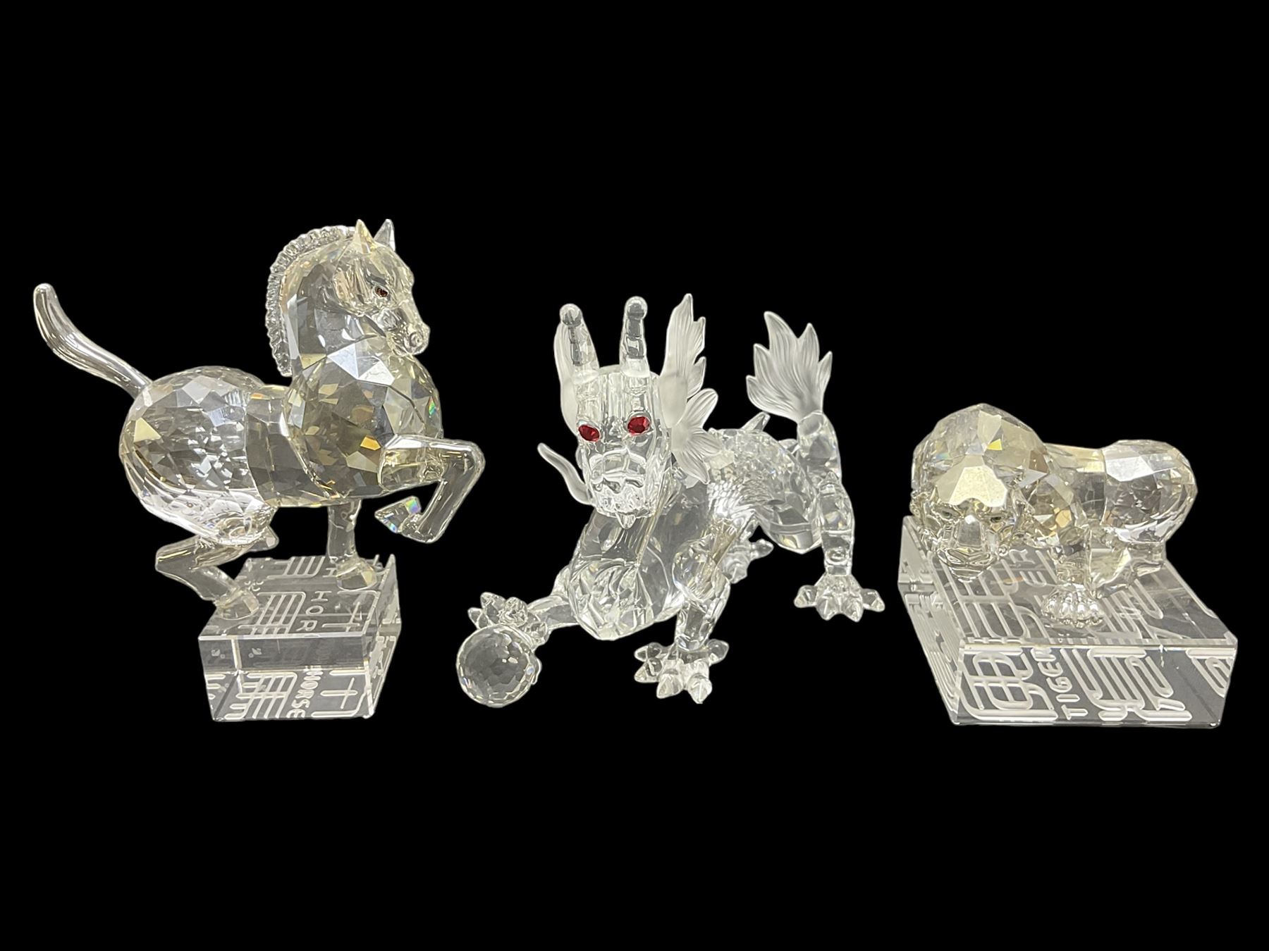 Two Swarovski Crystal Signs of the Zodiac figures, comprising horse and tiger, together with Zodiac dragon holding the flaming pearl, largest H11cm 