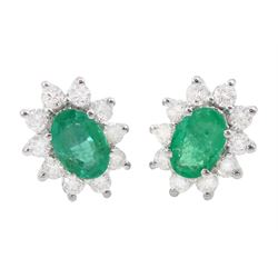 Pair of 18ct white gold emerald and diamond cluster earrings, each stud set with a single ...