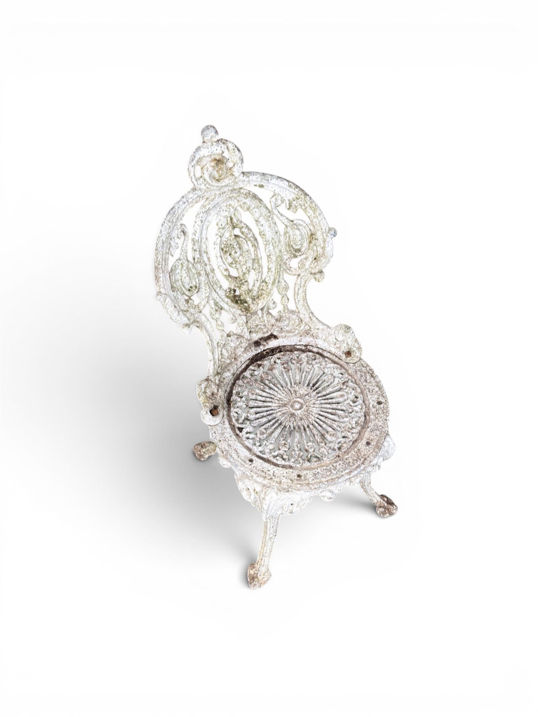 Pair of white painted cast metal garden chairs, ornate reclined backs, circular pierced seats on cabriole legs