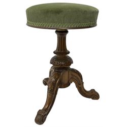 Late Victorian walnut piano stool, circular upholstered revolving seat, on fluted and carved column, three splayed supports carved with foliage and scrolls 