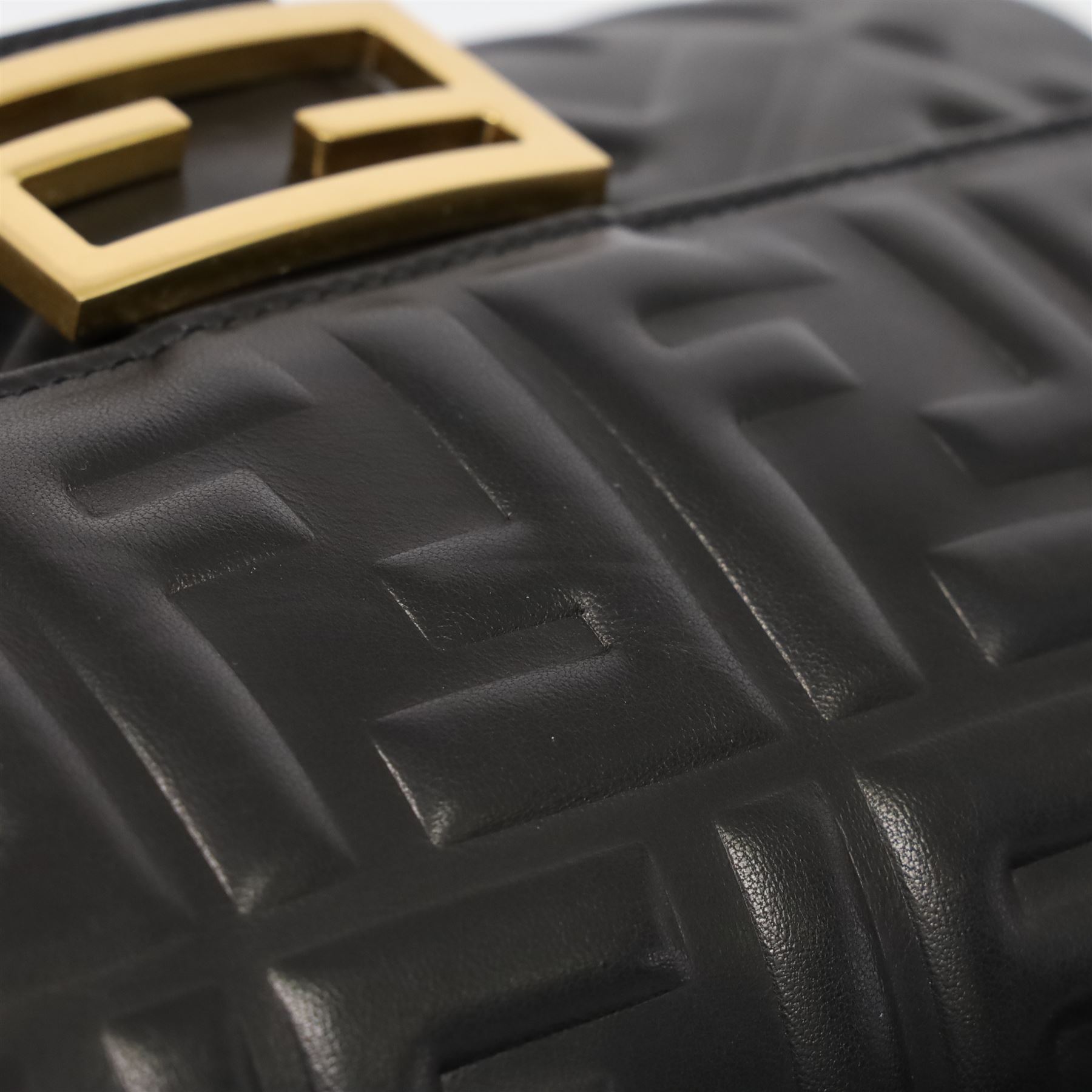 Fendi Baguette shoulder bag, black nappa leather with embossed FF monogram and quilted panels, the front flap secured by a gold-tone FF logo magnetic clasp engraved Fendi Made in Italy, with detachable leather shoulder strap and gold-tone hardware, interior leather tab stamped 'Baguette Fendi Made in Italy', together with original Fendi dust bag and box, W27cm D7cm H15cm