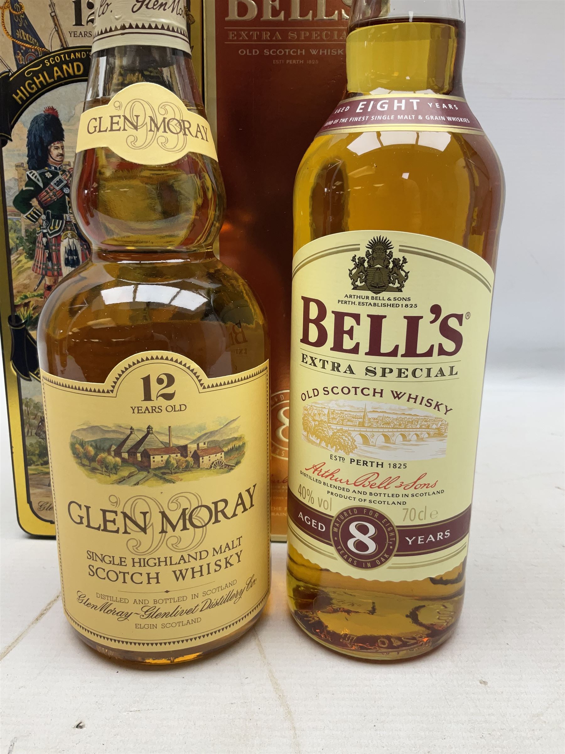 Glen Moray 12 Year Single Malt Highland Scotch Whisky, 70cl 40% vol, one bottle, in Highland Regiments The Black Watch presentation tin, Glenfiddich Pure Malt Scotch Whisky, Special Old Reserve, 70cl 40% vol, one bottle, in Clan Murray presentation tin, Bell's Extra Special Old Scotch Whisky, Aged 8 Years, 70cl 40% vol, one bottle, in box and Bell's Extra Special Old Scotch Whisky, 1l, 43% vol (4)