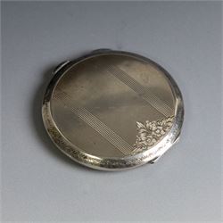 Two silver compact mirrors, comprising a Kigu powder compact with engine turned decoration and a compact mirror with floral decoration, both hallmarked