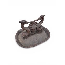 Victorian cast iron boot scraper, supported by two dolphins with central shell motif