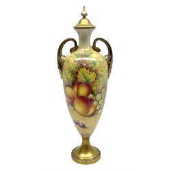 Mid/late 20th century Royal Worcester vase and cover decorated by Alan Telford, of slender ovoid form with scroll handles, and gilt cover, upon a gilt circular pedestal foot, the body hand painted with a still life of fruit upon a mossy ground, signed Telford, with black printed mark beneath and painted shape number 2710, H25cm