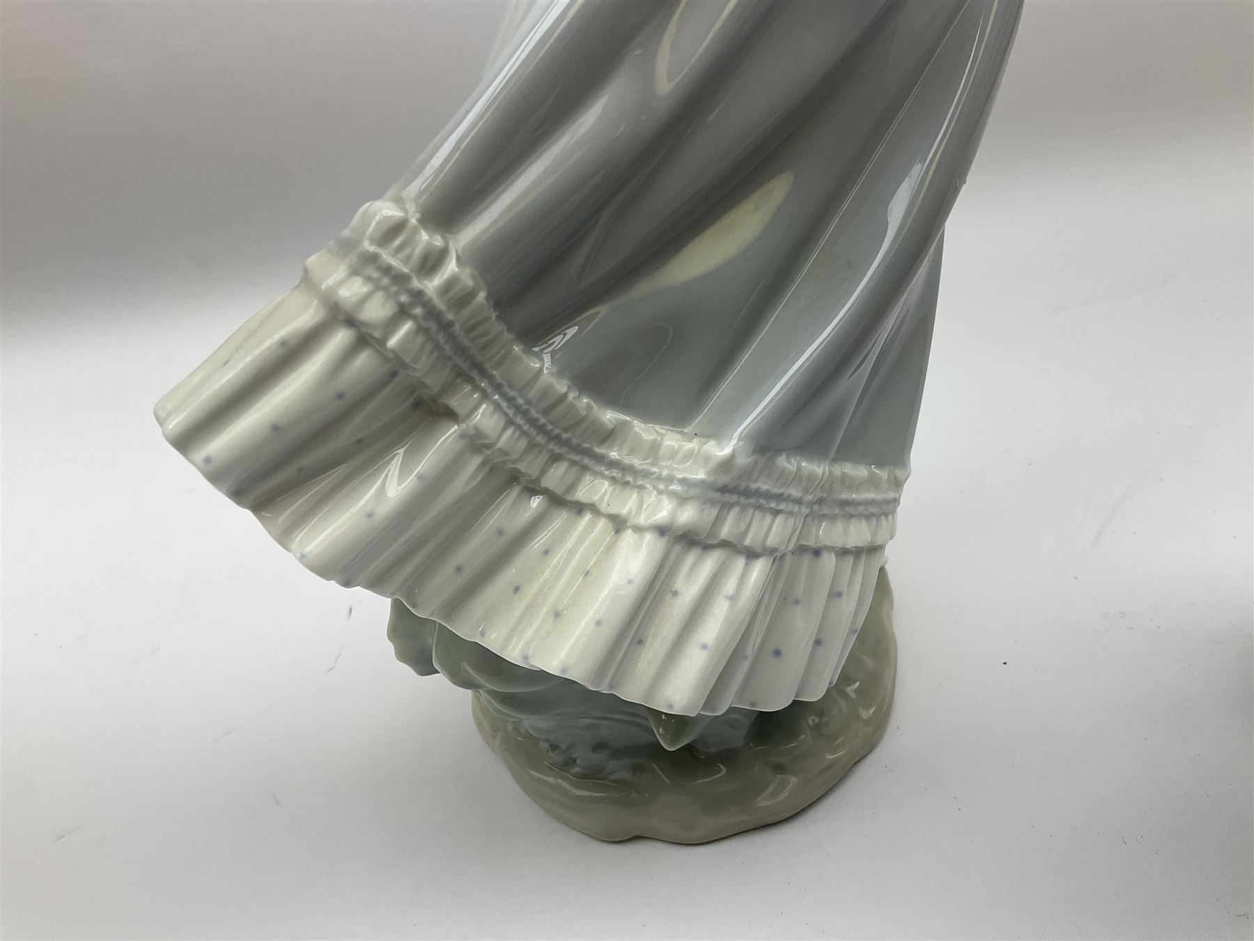 Three Lladro figures, comprising, Dreams of Summer Past no 6401, Spring Breeze no 4936 and Breezy Afternoon 5682 together with Lladro plaque Art Brings us Together no 7677, all in original boxes, largest example H35cm