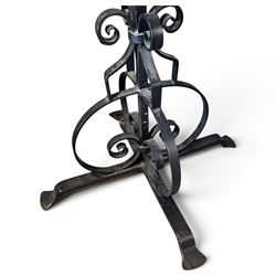 Collection of wrought iron candle stands, comprising five-light and three-light floor-standing candelabra with scrolling branches, and a pair of five-light table candelabra of naturalistic branching form