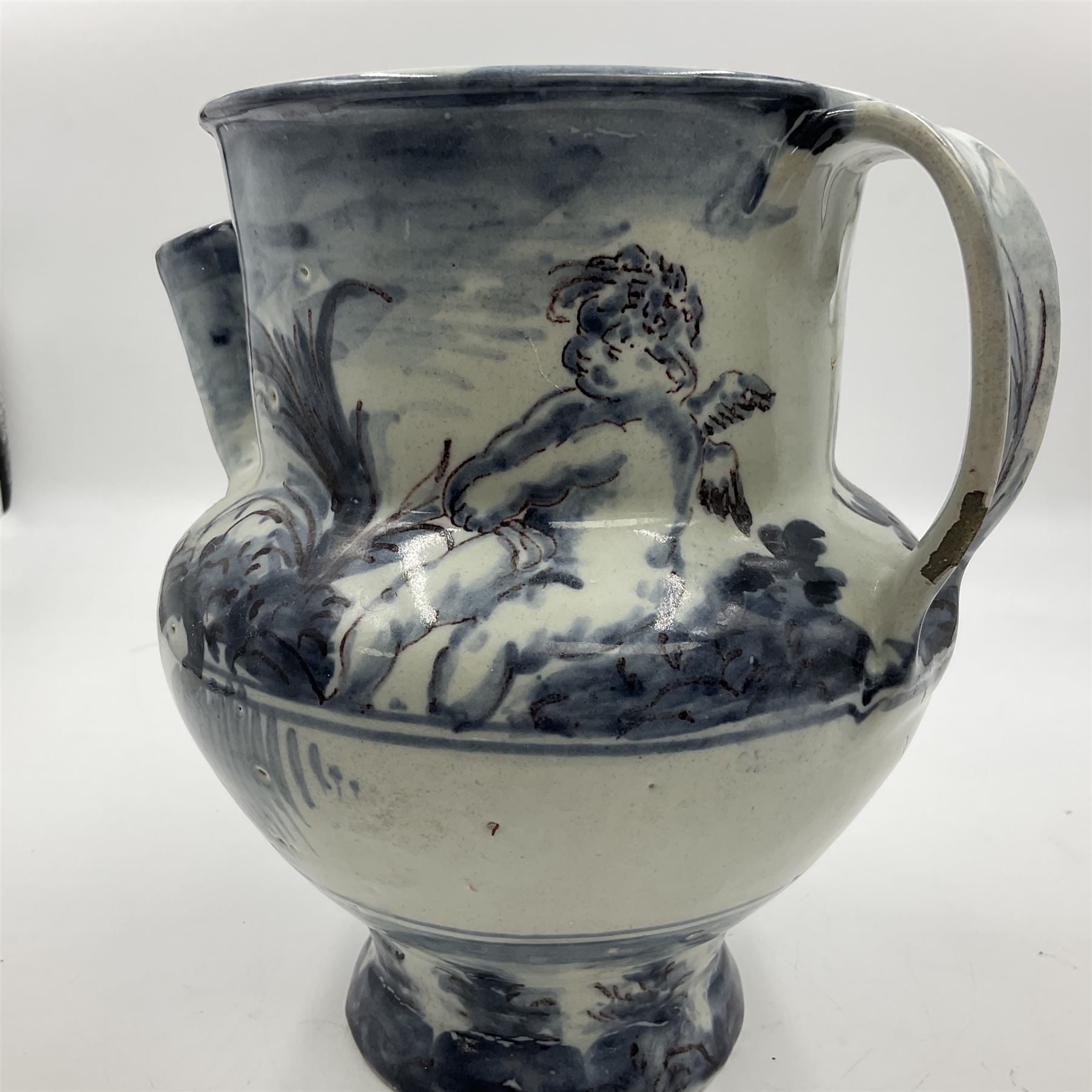 Tin glazed earthenware wet drug jug, decorated with cherubs in a landscape, H90cm 