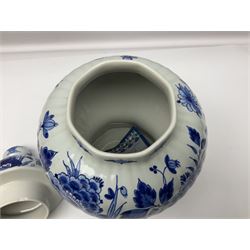 De Porceleyne Fles Delftware blue and white covered jar, of fluted baluster form, with floral and insect decoration, upon an octagonal foot, the octagonal cover with urn shaped finial, H32cm