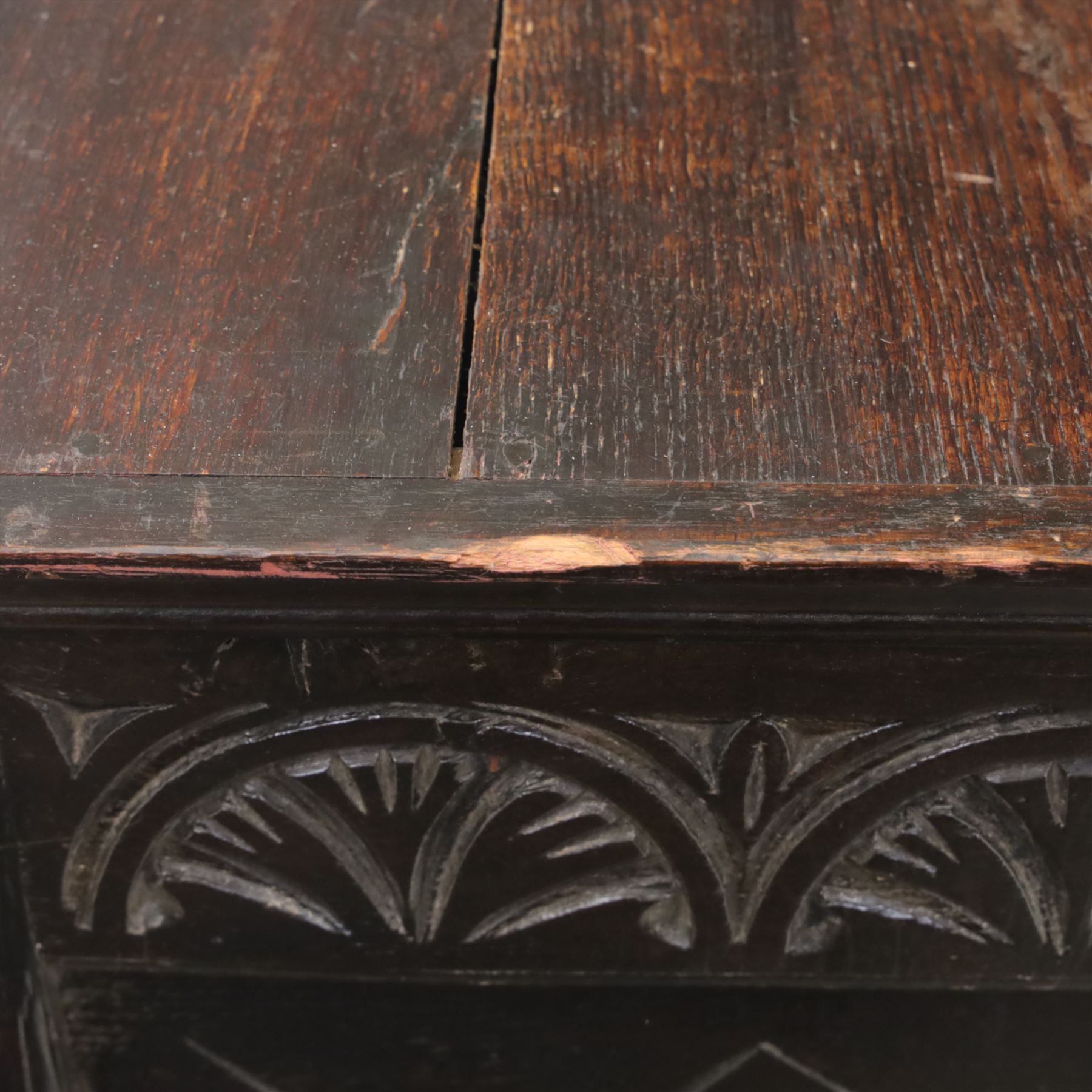 19th century oak cupboard cabinet, the moulded rectangular top above a deeply carved front carved with frieze of lunettes above a central panelled cupboard door with lozenge and foliate carving, flanked by vertical carved panels, upon turned legs with boarded lower shelf
