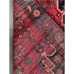 Persian Hamandan rug, red ground field decorated with large central medallion, stylised flower heads and bird motifs