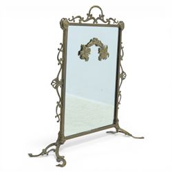 Mirrored brass firescreen, with scrolled frame on scrolled legs 