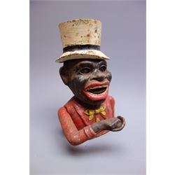  Cast iron mechanical money box as the head and shoulders of a jolly man wearing a white top hat, red jacket and yellow bow-tie H20cm  