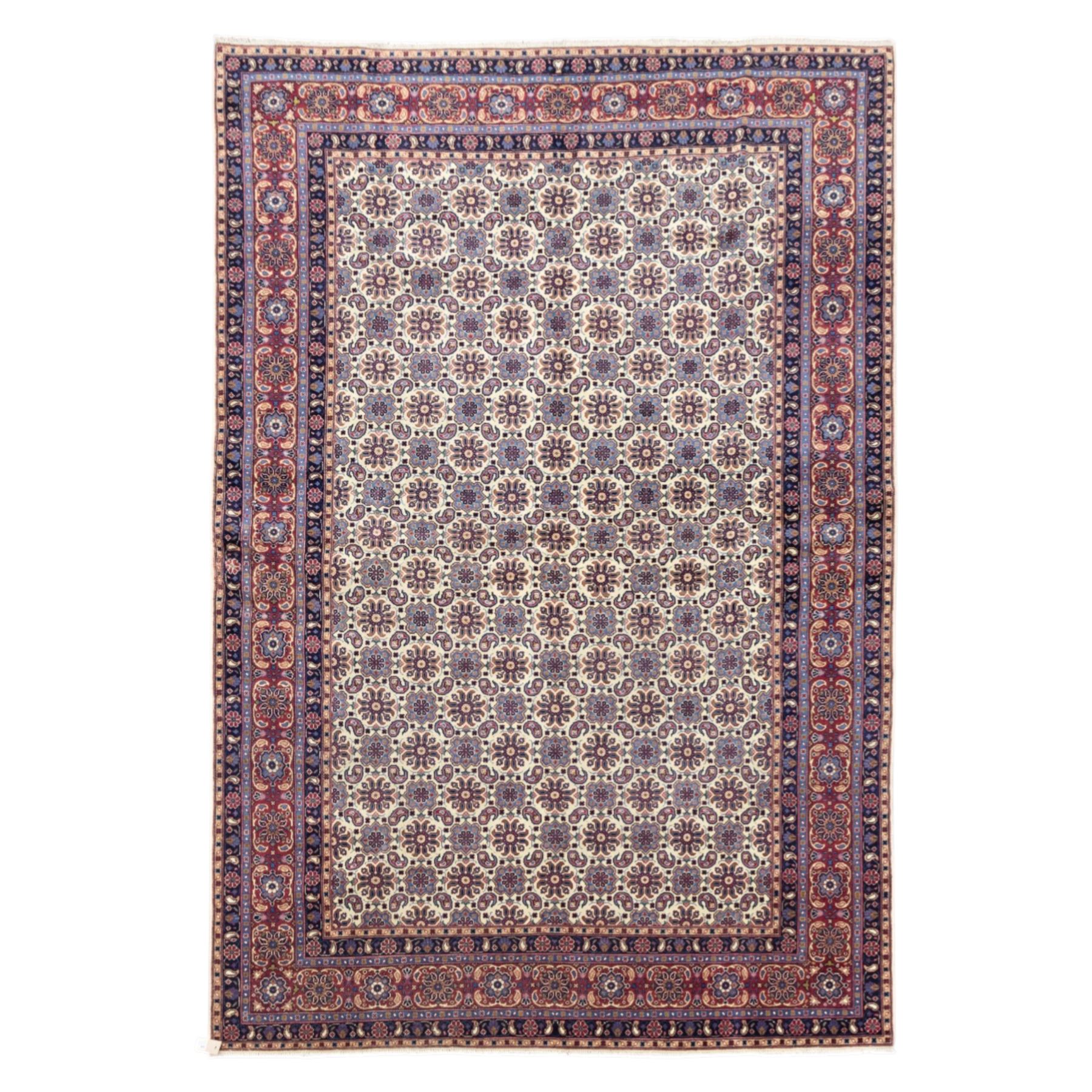 North West Persian Tabriz hand-knotted carpet, ivory field densely decorated with an all-over Herati style (Mahi) lattice composed of stylized rosettes and scrolling leaves, enclosed by a broad madder-red border of palmette and floral vine design, between navy guard stripes, cotton fringe ends 