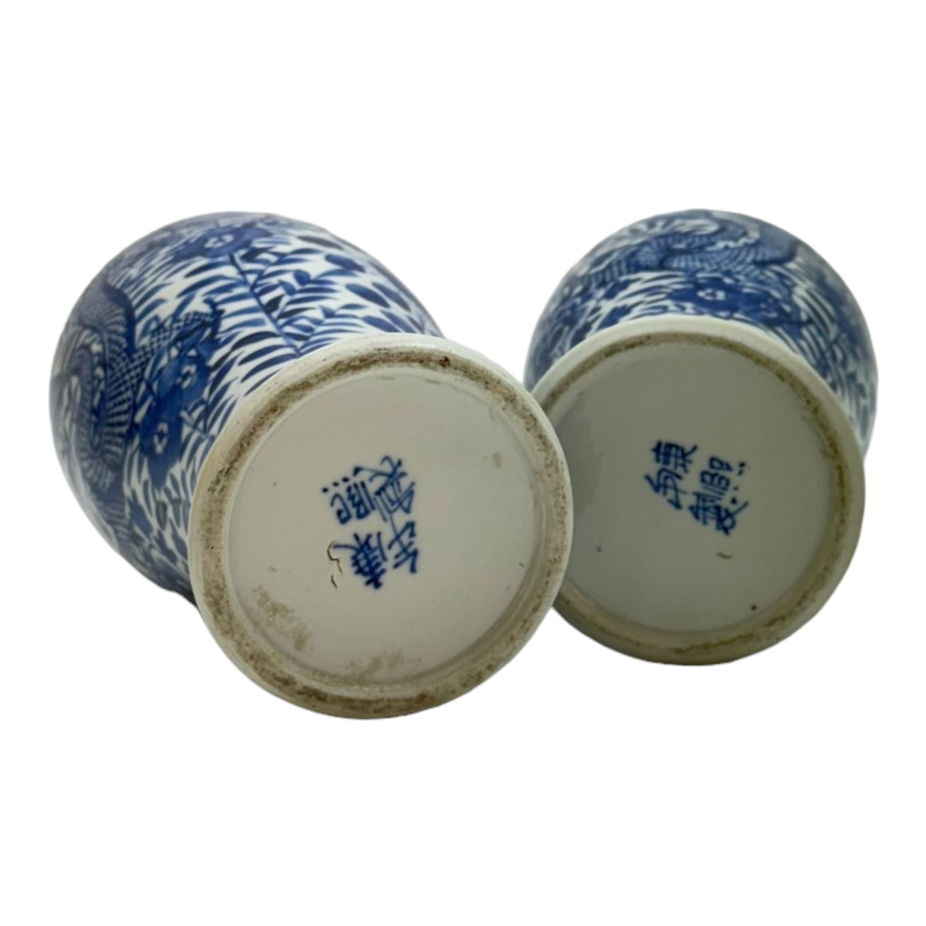 Pair of Chinese vases and covers, of baluster form the blue and white design depicting dragons in foliage, with character marks beneath, H38cm
