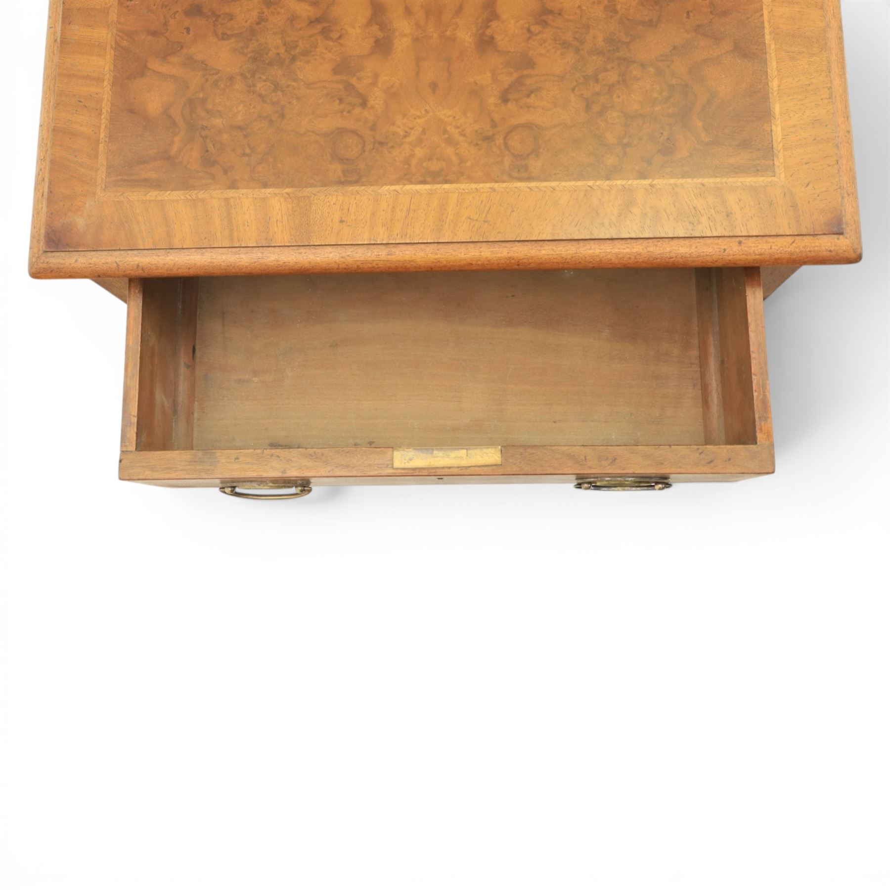 Traditional design pair of walnut lamp tables, figured top with crossbanded edge, above a single frieze drawer with brass oval handles, raised on turned supports