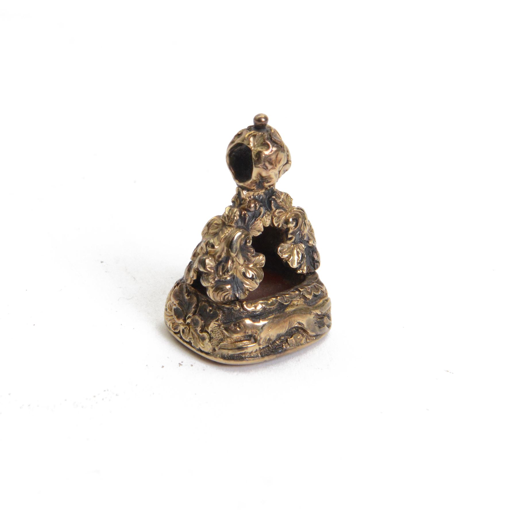 Late 18th/early 19th century 12ct gold fob seal, the carnelian matrix engraved with the Chichester family coat of arms, depicting a chequy shield beneath a crest of a heron with an eel in its beak, within a scrolling foliate mount, the sides detailed with a hound in chase and birds, H3cm

Provenance: By family descent from the Chichesters of Arlington Court, Devon; from the collection of Andrew Chichester Everitt.
