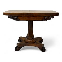 Early Victorian rosewood card table, rectangular foldover swivel top with rounded corners, red baize-lined surface, frieze adorned with carved foliate motifs, supported by a central octagonal waisted column on shaped quatrefoil base, terminating in scrolled feet with concealed metal castors