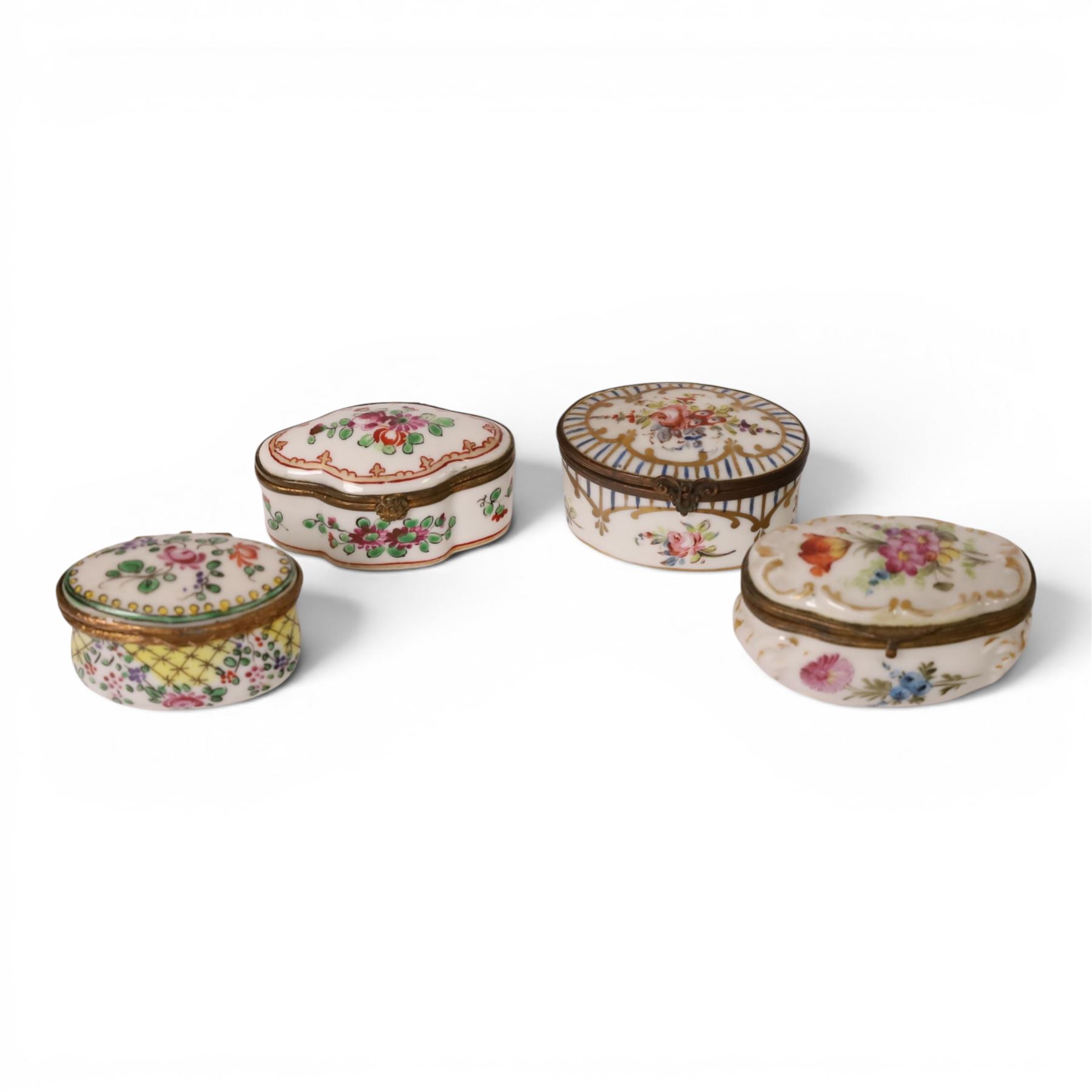 Four 19th century and later pill boxes, each decorated to the lid with floral sprigs, H3cm