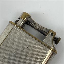 A Dunhill silver plated cigarette lighter, with engine turned panels to the body, marked to arm Dunhill Reg No 737418, marked beneath Pat No 390107 Made in England, H5cm. 