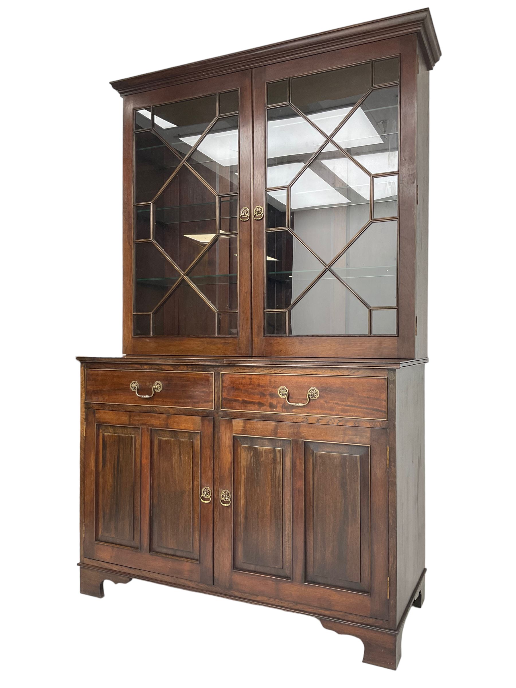 Acorn Industries - Georgian design mahogany bookcase on cupboard, fitted with two astragal glazed doors enclosing three glass shelves, base with two cock-beaded drawers over two panelled cupboards, inlaid with acorn signature, by Alan Grainger, Brandsby
