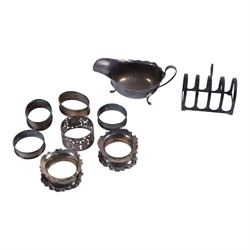 Group of silver, comprising 1930s silver five bar toast rack, 1940s silver sauce boat, thr...