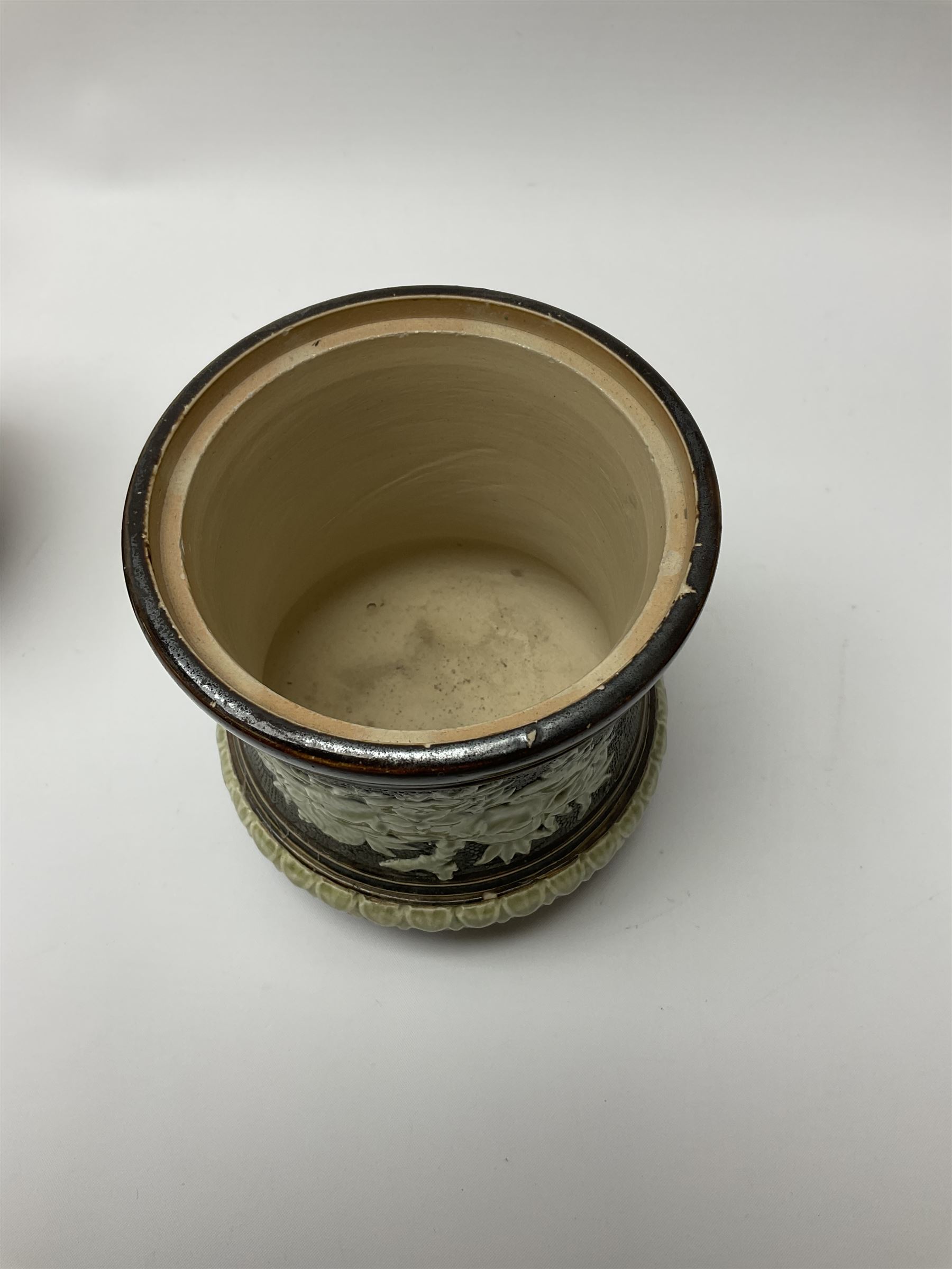 A group of Doulton Lambeth and Royal Doulton tobacco jars, to include examples with relief moulded foliate decoration, each with impressed marks and markers monograms beneath. 