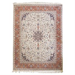 Persian ivory ground Kashan carpet, the busy field decorated with a central floral pole me...