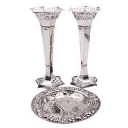 Pair of early 20th century silver specimen vases, each of facetted trumpet form with pierced flared rim, upon spreading filled foot, hallmarked Thomas Bishton, Birmingham 1911, H19.5cm, together with a 20th century Maltese silver dish, of circular form, with flower head centre and embossed flower heads to rim, various marks including purity 917 mark, D15cm, approximate weighable silver 3.19 ozt (99.1 grams)