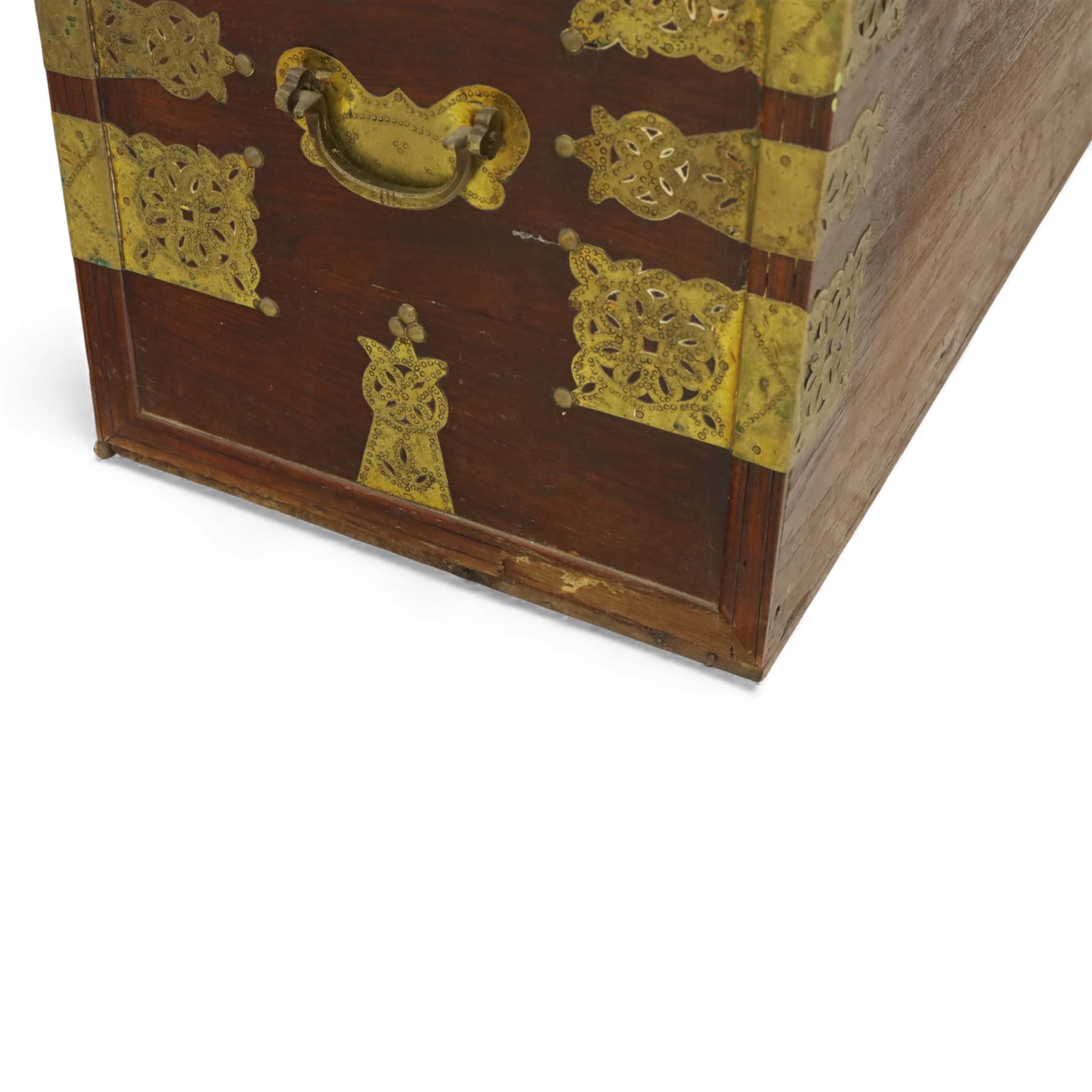 Early 20th century brass-mounted hardwood chest, the hinged top and front richly decorated with applied and studded brass panels and pierced lock escutcheon, revealing a candle box, reinforced with brass corner mounts