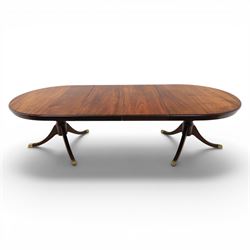 Regency design mahogany extending twin pedestal dining table with two additional leaves, raised on splayed supports terminating brass paw feet
Extends to 268cm