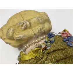 Victorian large wax over composition Pumpkin head doll, with inset dark glass eyes, moulded blonde hair in curls, stuffed body with carved and painted wooden limbs, grey painted boots, floral satin dress with netting underclothes H61cm