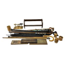 Silver mounted walking stick hallmarked London 1915, quantity of further sticks and canes, brass postal scales with weights on rectangular wood base, three wood cribbage boards, one having brass mount, Mauchlin Ware boxes to include money box example, book trough etc