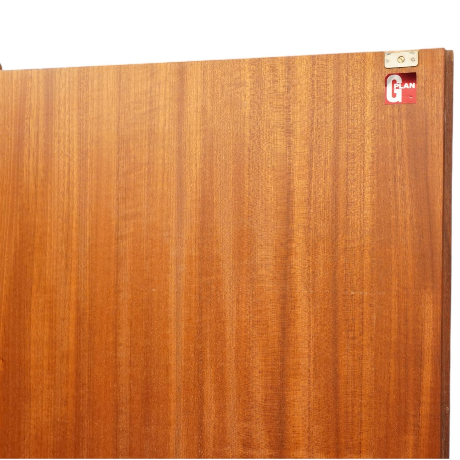 G Plan - 'Fresco' teak double fitted gentleman's wardrobe, twin doors enclosing two sections, a single clothes rail and drawers and shelving, on a recessed plinth base