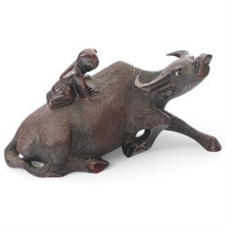 Chinese carved hardwood model of an ox or water buffalo, with attendant upon back, upon a carved openwork stand with cabriole lets, model H6.5cm L13cm